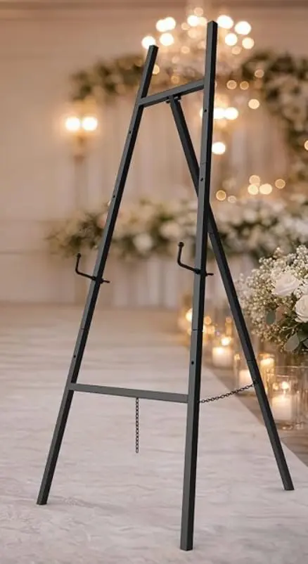 Sleek black metal easel designed to display welcome signs, seating charts, lightweight mirrors and framed signage at weddings and special events. Features four adjustable display heights. Supports items weighing up to 25 lb.