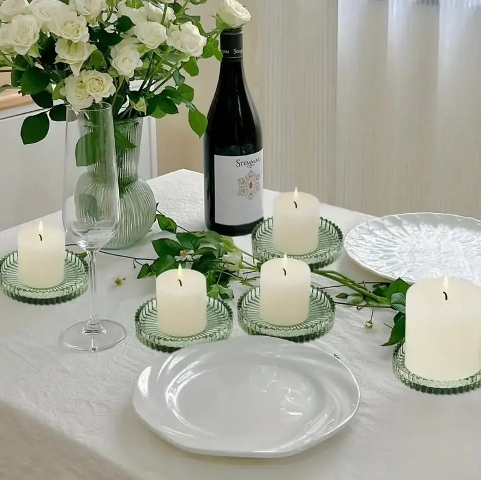 Rich green glass pillar candle holders that add a botanical, organic element to tablescapes. The green tone complements our sage napkins and pairs beautifully with vineyard and garden settings. Holds standard 3-inch pillar candles.