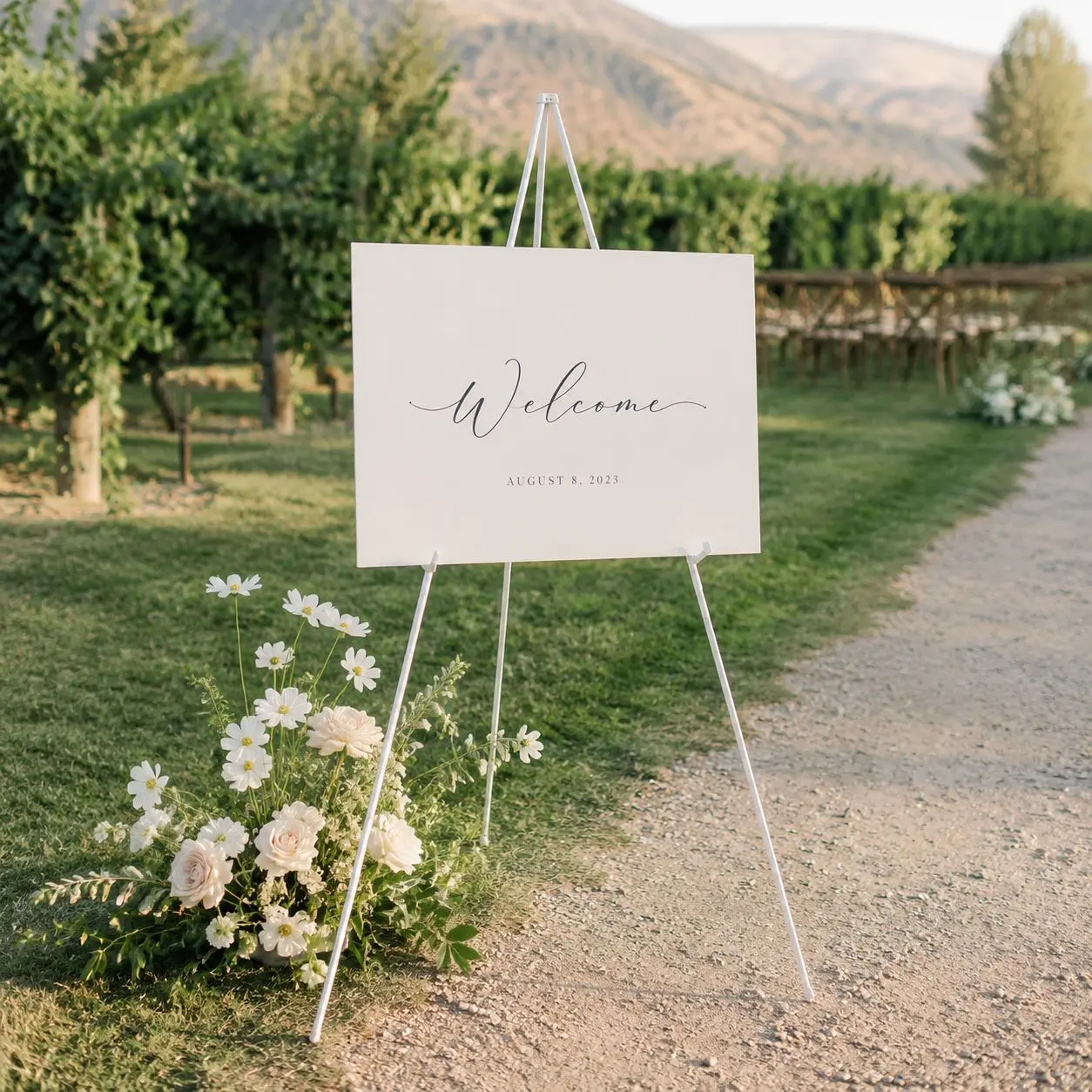Sleek white metal easel designed to display welcome signs, seating charts, and more at weddings and special events. Supports items weighing up to 5 lb.
