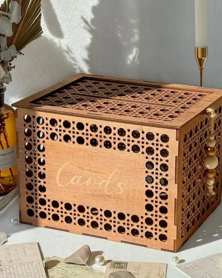 Charming wooden card box with bohemian styling. Features a slot for cards and envelopes with a secure closure. The natural wood finish adds warmth and rustic character to your gift table. Pairs beautifully with our guestbook sign and display plinths.