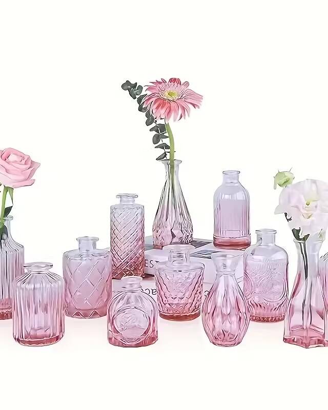 A box of 12 mini pink glass bud vases for single-stem floral displays. The soft blush tone adds romantic warmth to tablescapes and pairs perfectly with our pink glass candle holders. Ideal for spring weddings, bridal showers, and garden parties.