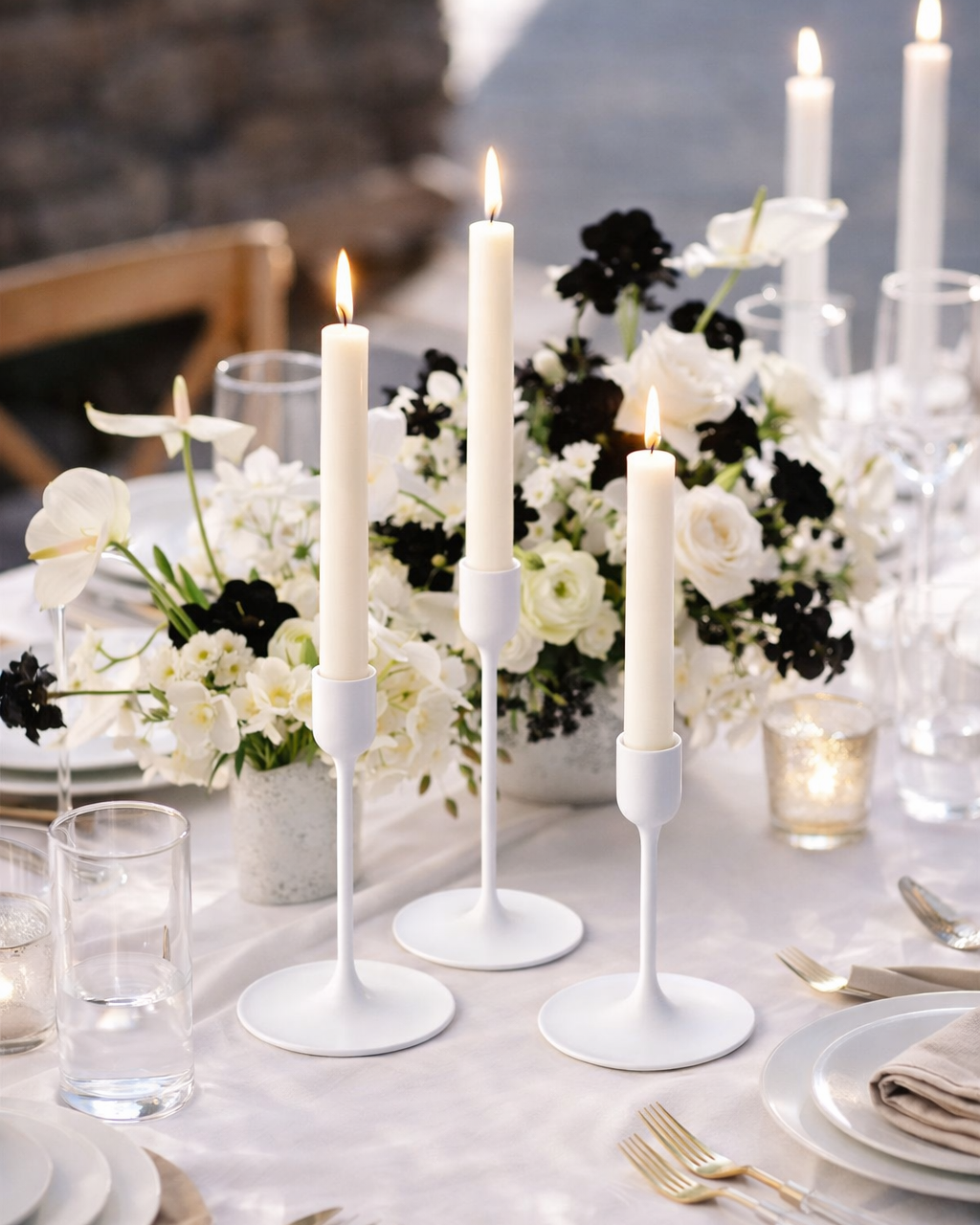 Set of three white ceramic taper candle holders in graduated heights. A classic choice that blends seamlessly with any table setting. The matte white finish gives a clean, timeless look that pairs beautifully with our cream napkins and velvet runners.